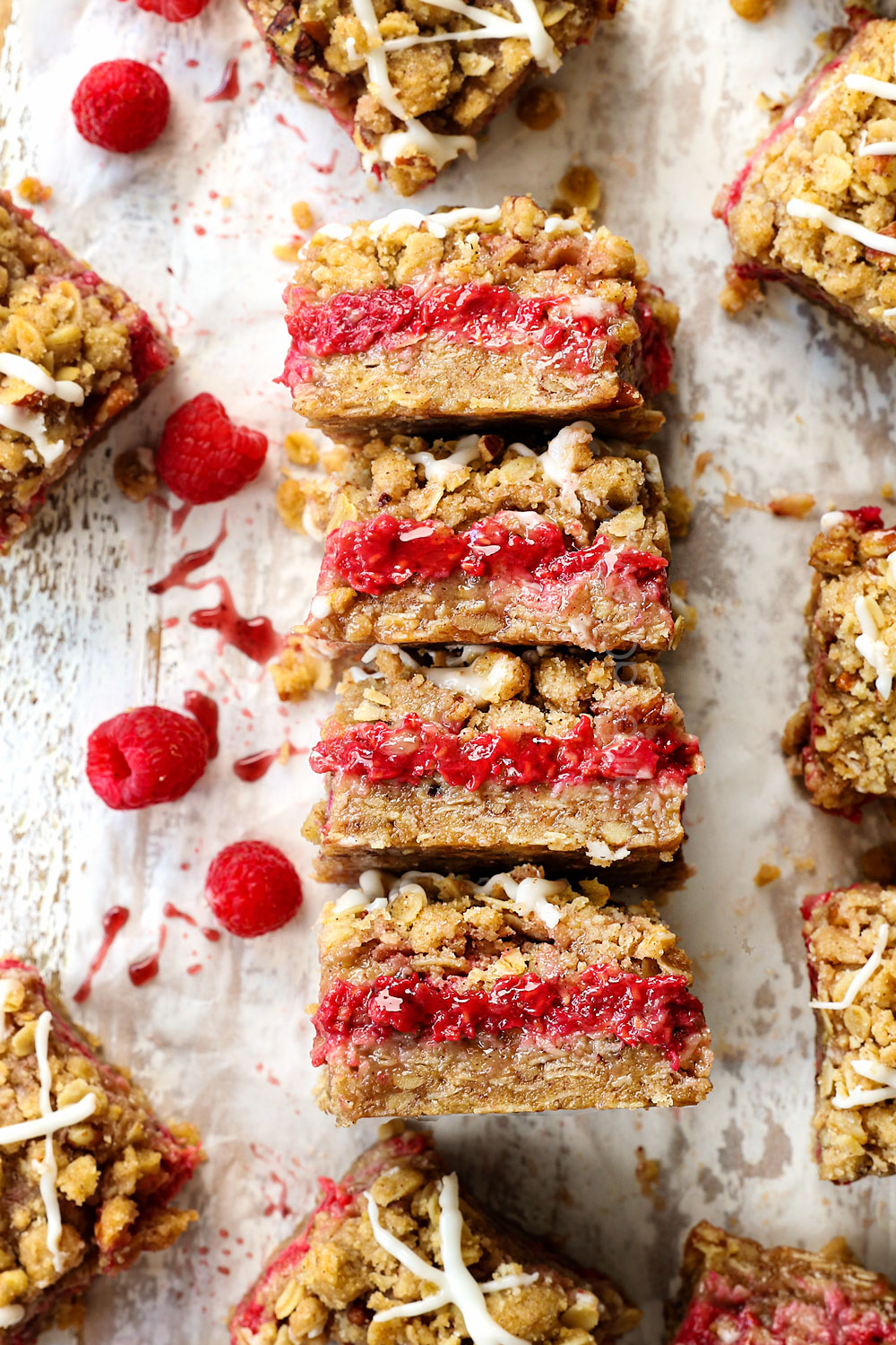 raspberry crumble bars recipe on their side showing the juicy raspberry jam filling