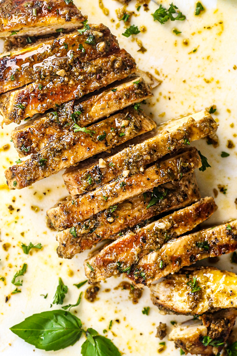 top view of Italian chicken marinated in lemon, red wine vinegar, and Italian seasonings on a cutting board showing how juicy it is