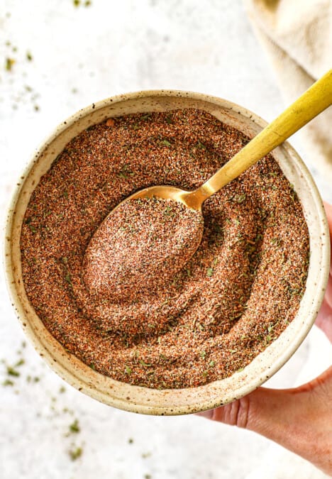 showing how to make Jamaican jerk seasoning by whisking the spices together in a bowl
