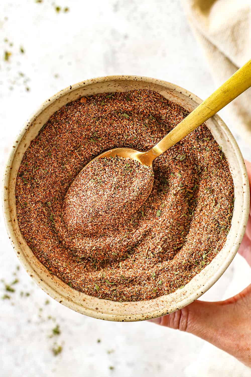 showing how to make Jamaican jerk seasoning by whisking the spices together in a bowl