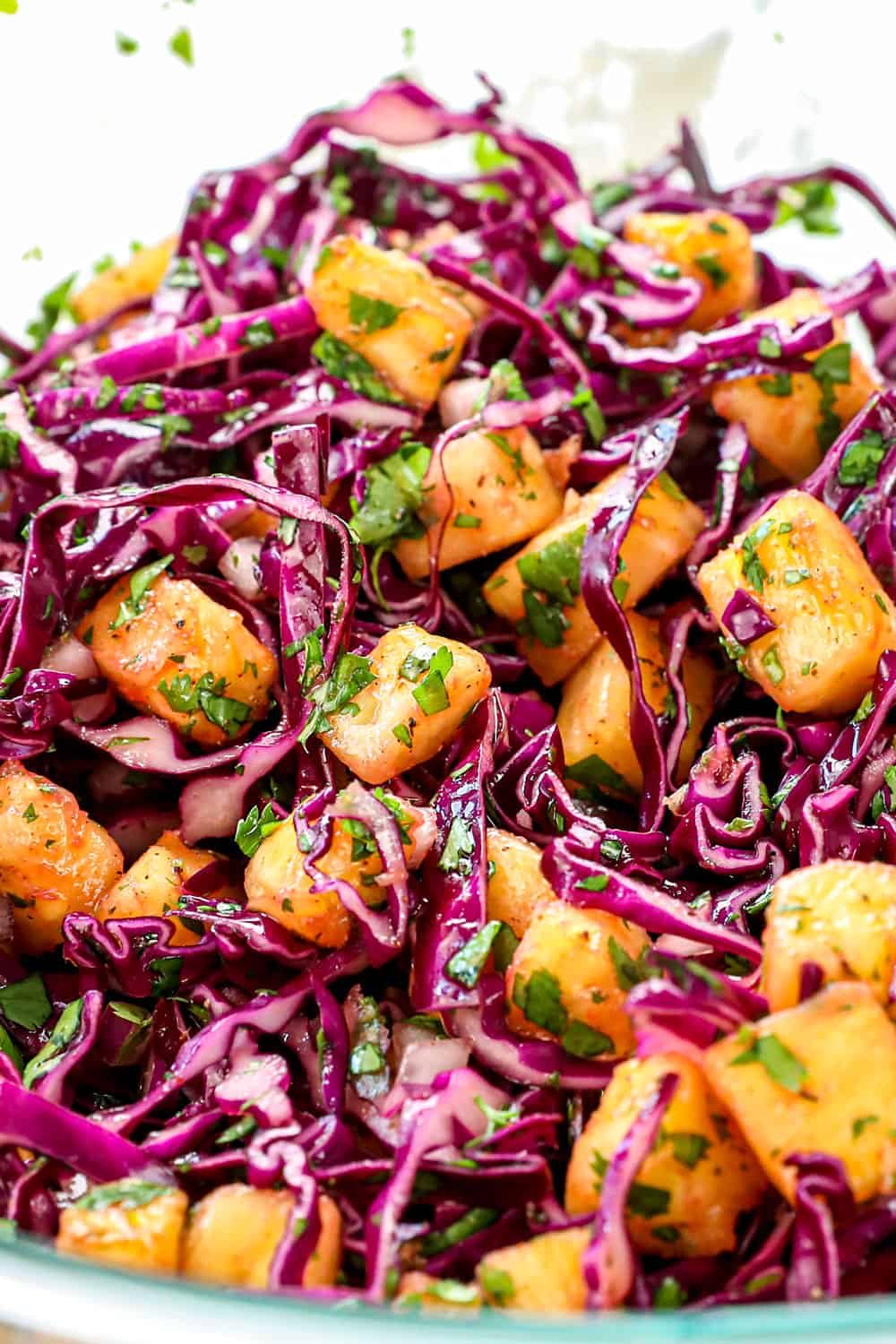 showing how to make chicken jerk tacos recipe by making pineapple slaw