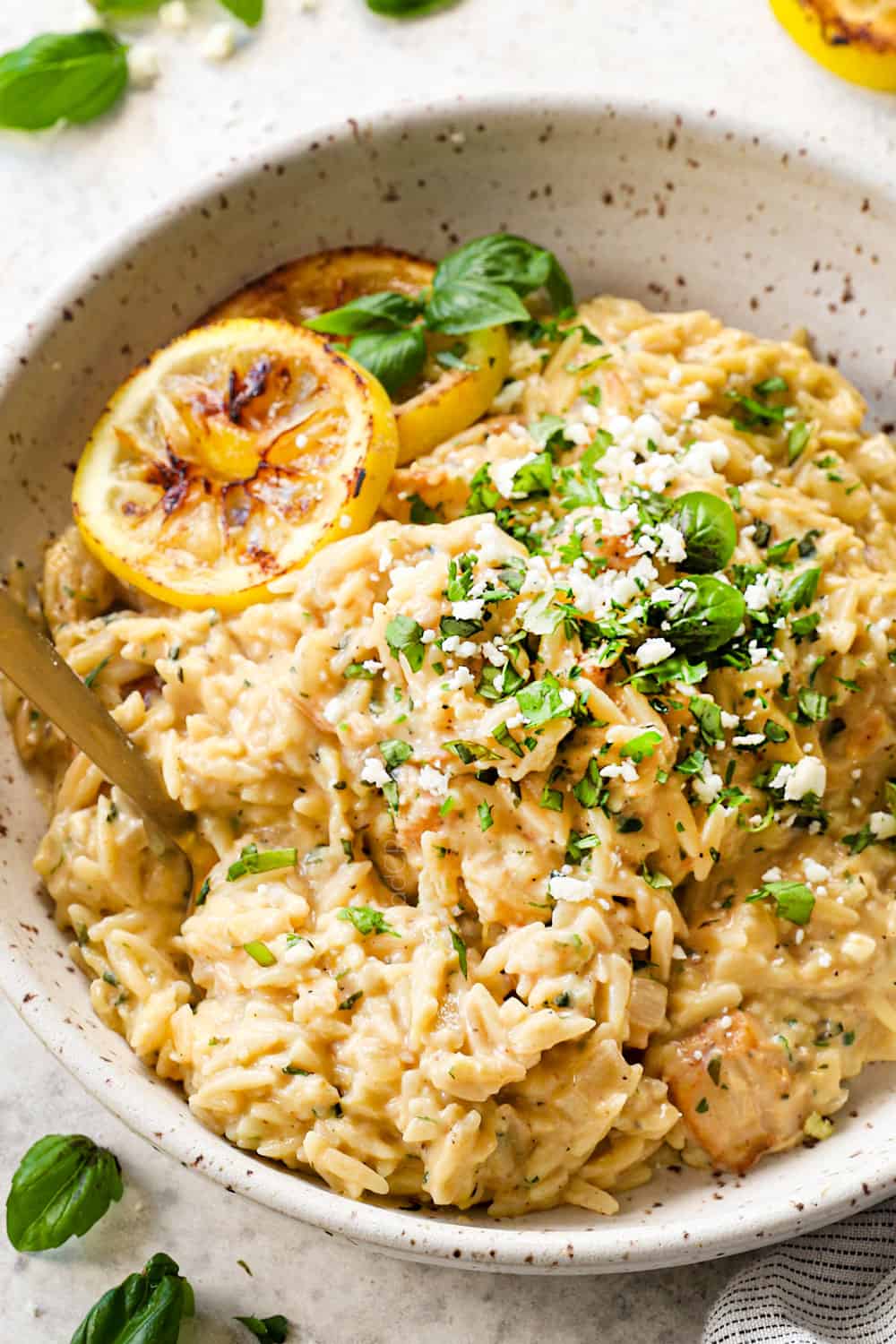 a fork taking a bite of lemon chicken orzo showing how creamy it is