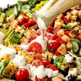 up close of pouring homemade ranch dressing recipe showing how creamy it is