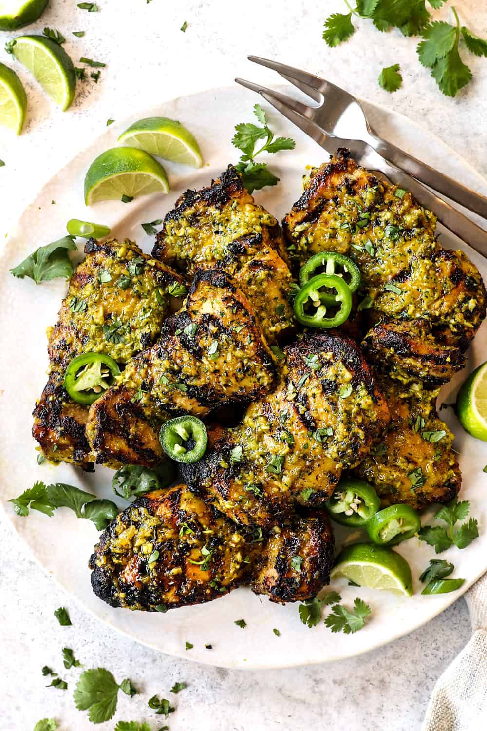 top view of grilled thai chicken thighs on a plate garnished with cilantro