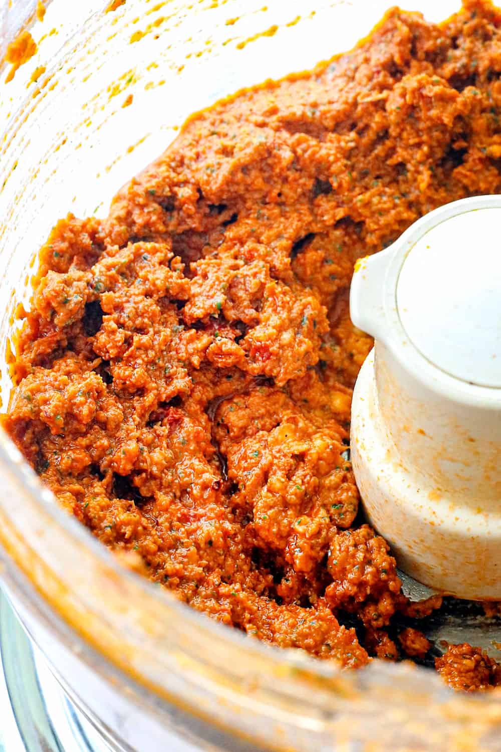 showing how to make couscous salad recipe by blending sun dried tomatoes, basil and feta together
