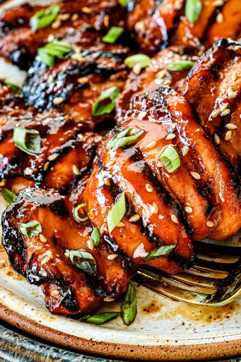 up close of boneless grilled chicken thighs showing how juicy they are