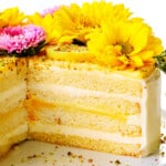 layer cake sliced open showing the layers of frosting, cake and lemon curd