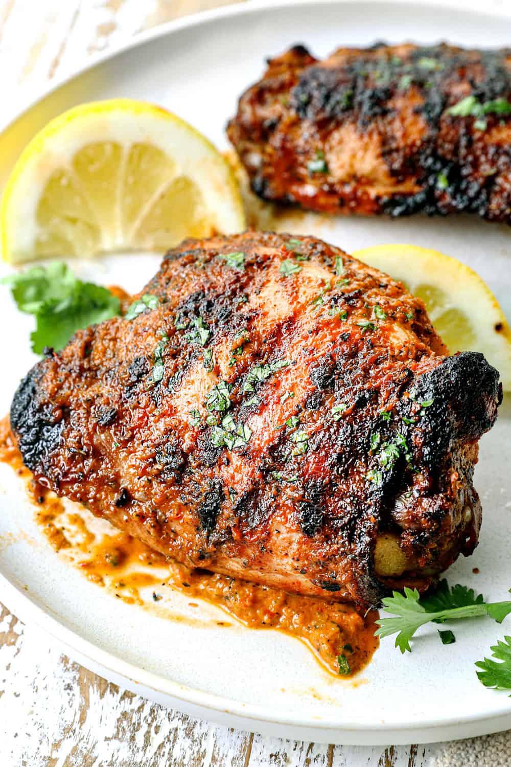 up close of peri peri chicken recipe (piri piri chicken) on a plate marinated in peri peri sauce