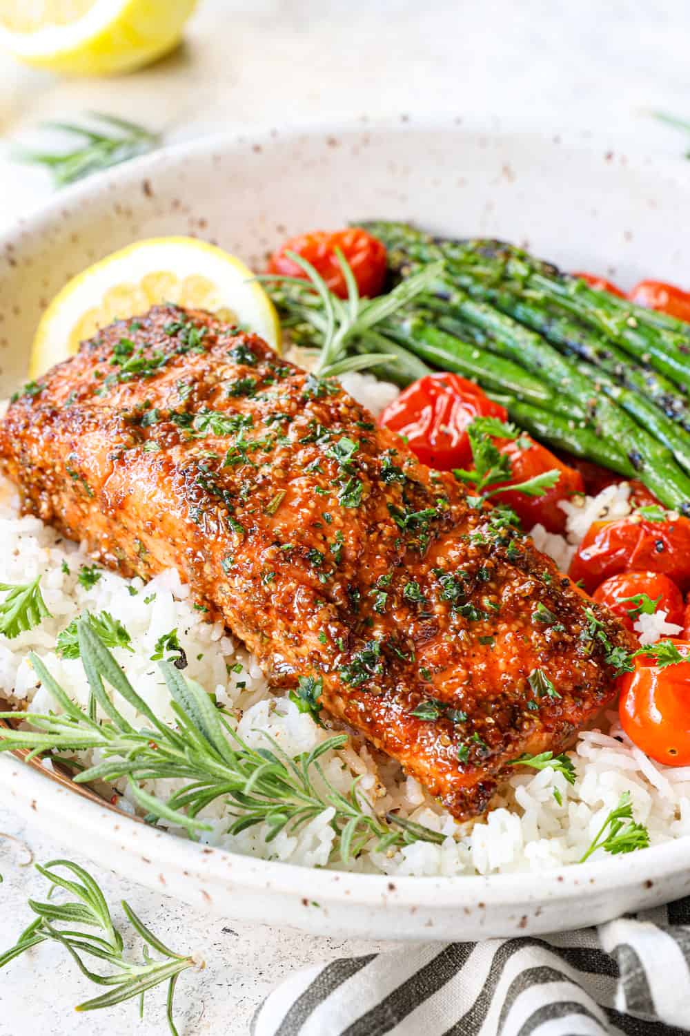side view showing how to serve cedar planked salmon in a bowl with rice and vegetables garnished with parsley