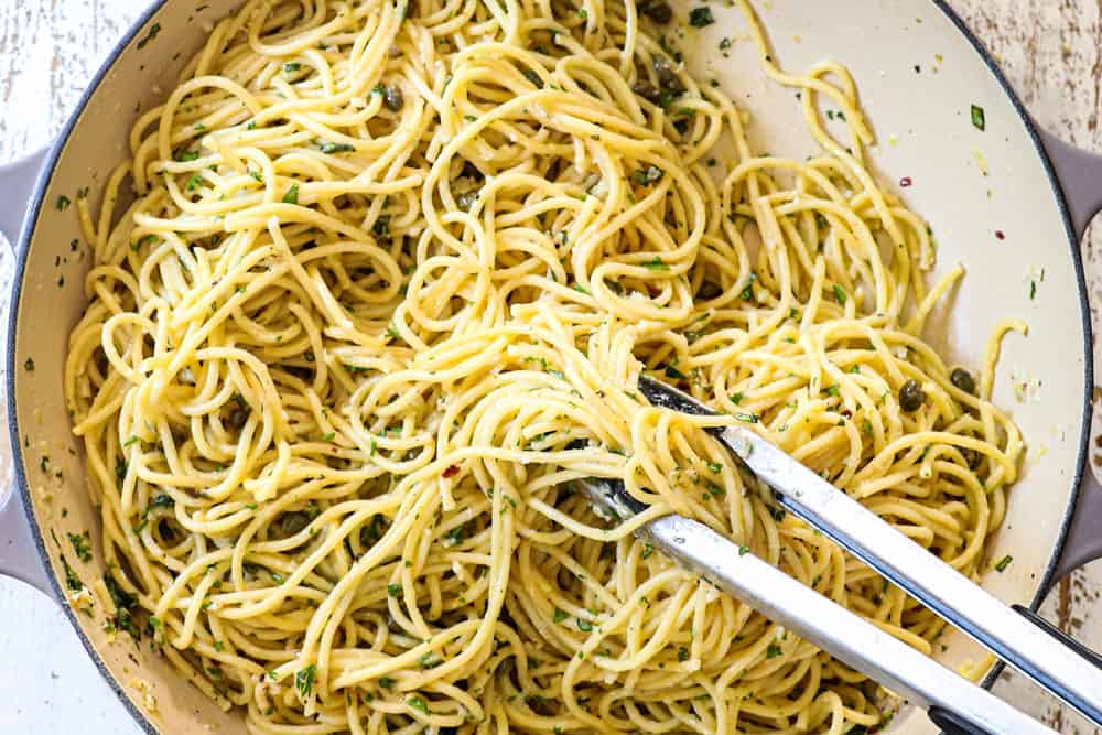 showing how to make lemon pasta (pasta al limone) by tossing pasta with lemon sauce and starchy water