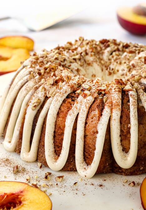 up close of peach cake recipe with fresh peaches garnished with pecans