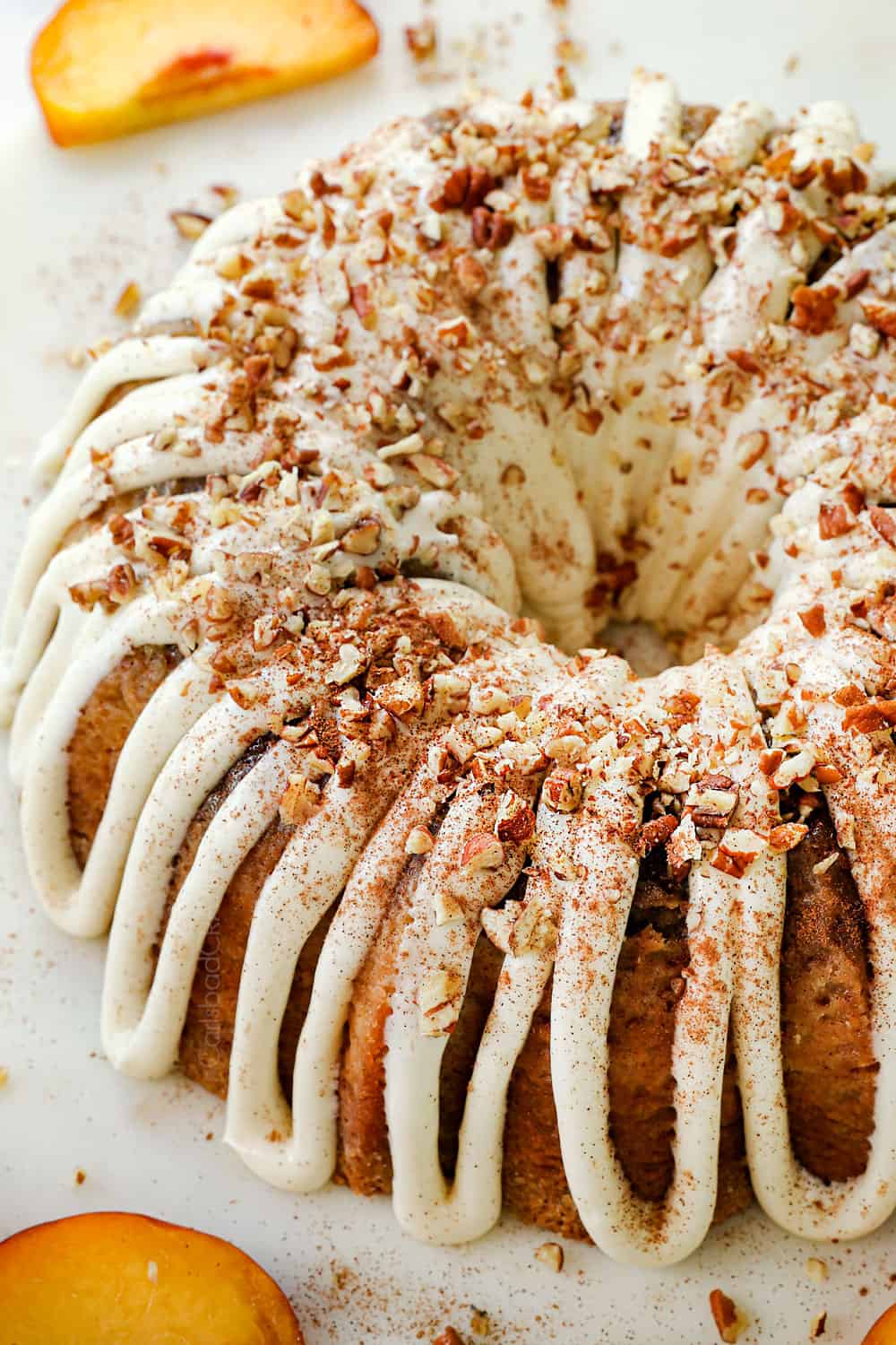 peach cobbler pound cake with chunks of peaches garnished with pecans