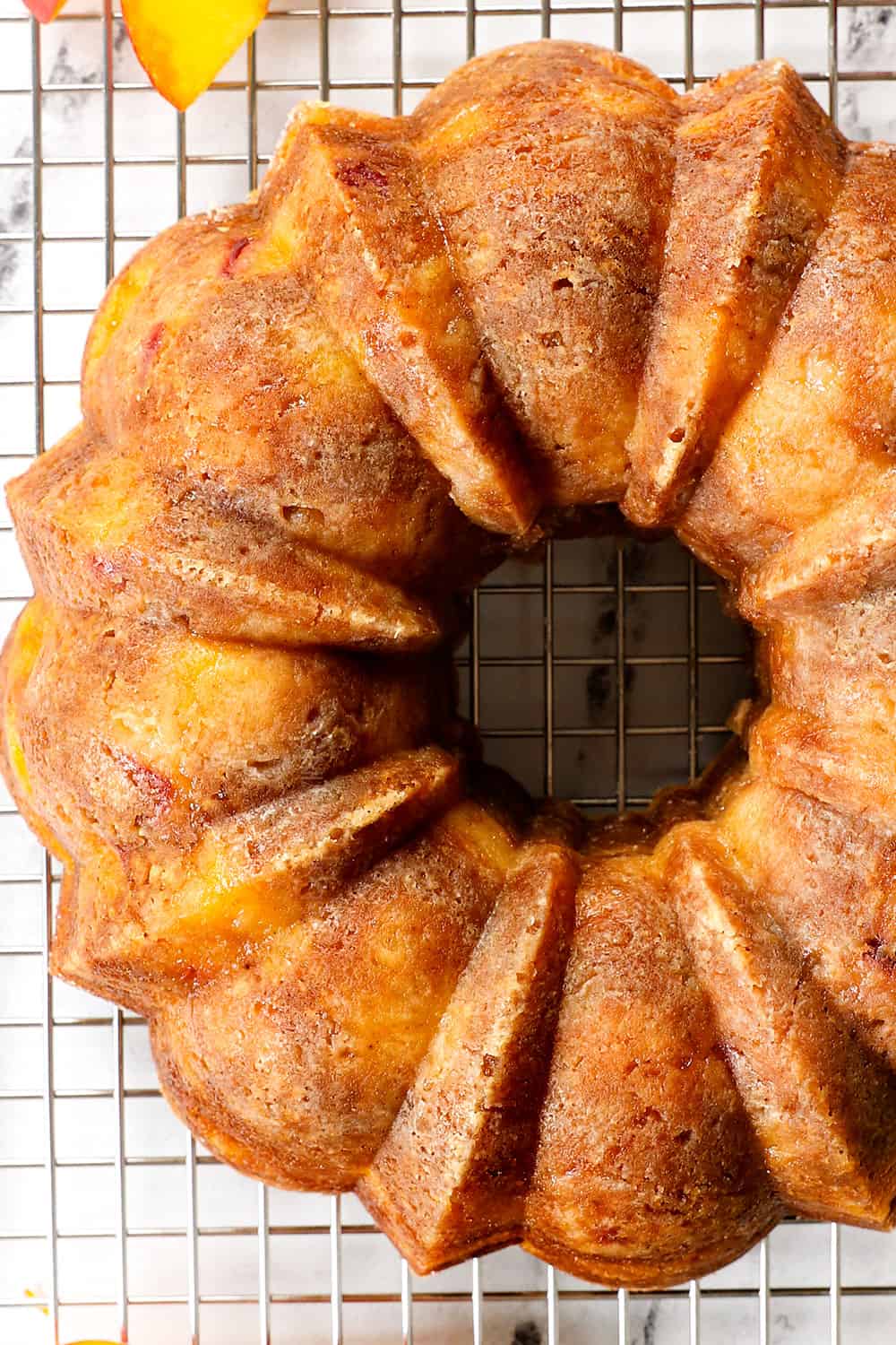 showing how to make peach cake recipe by chilling on a baking rack