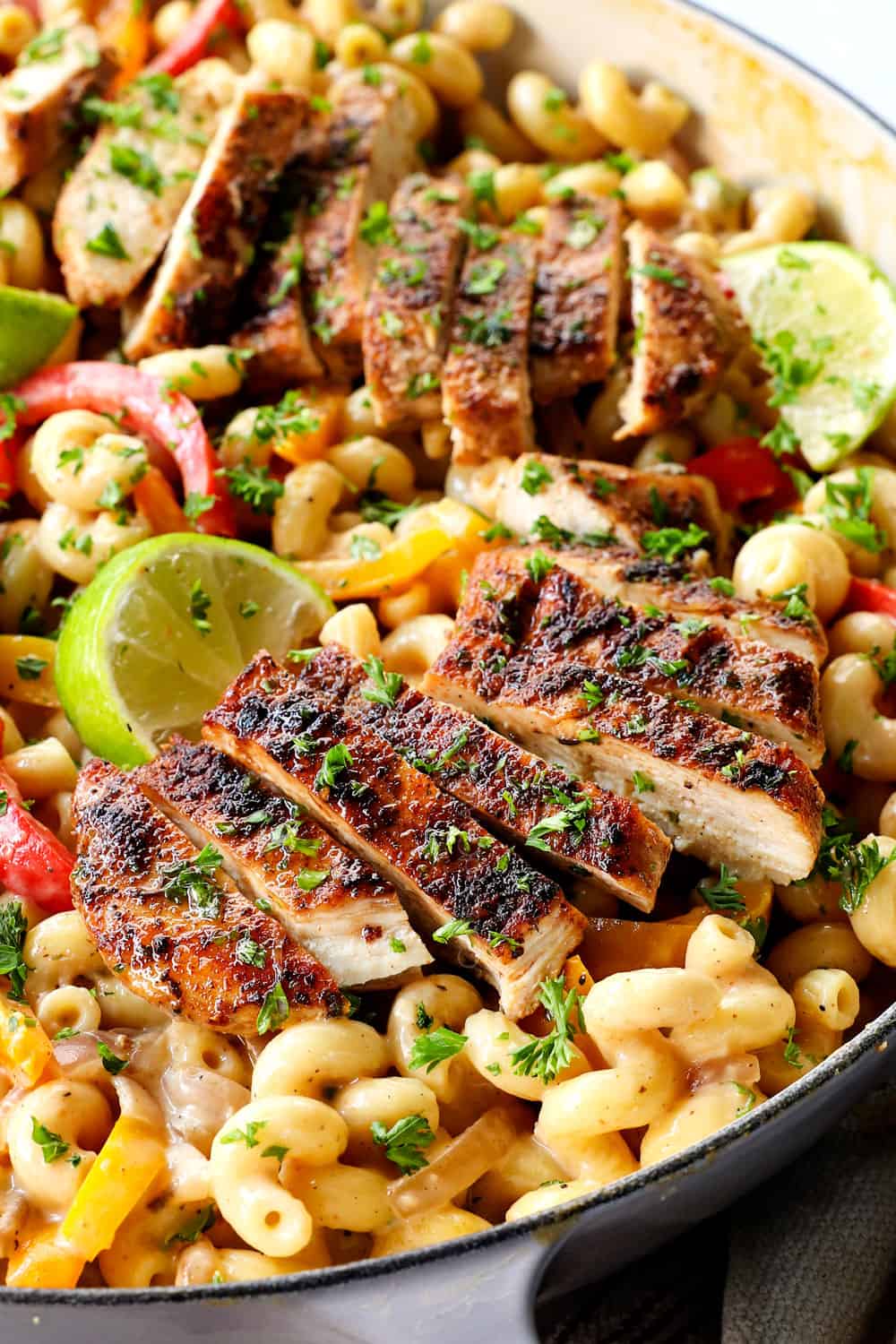 up close of jerk chicken pasta (Rasta pasta) showing how juicy chicken is