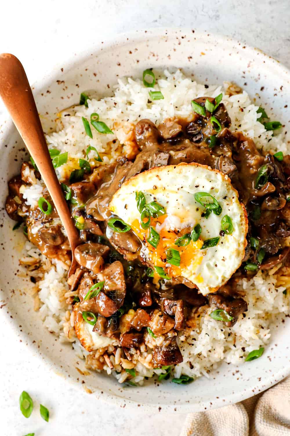 top view of moco loco with a fried sunny side egg with a broken yolk