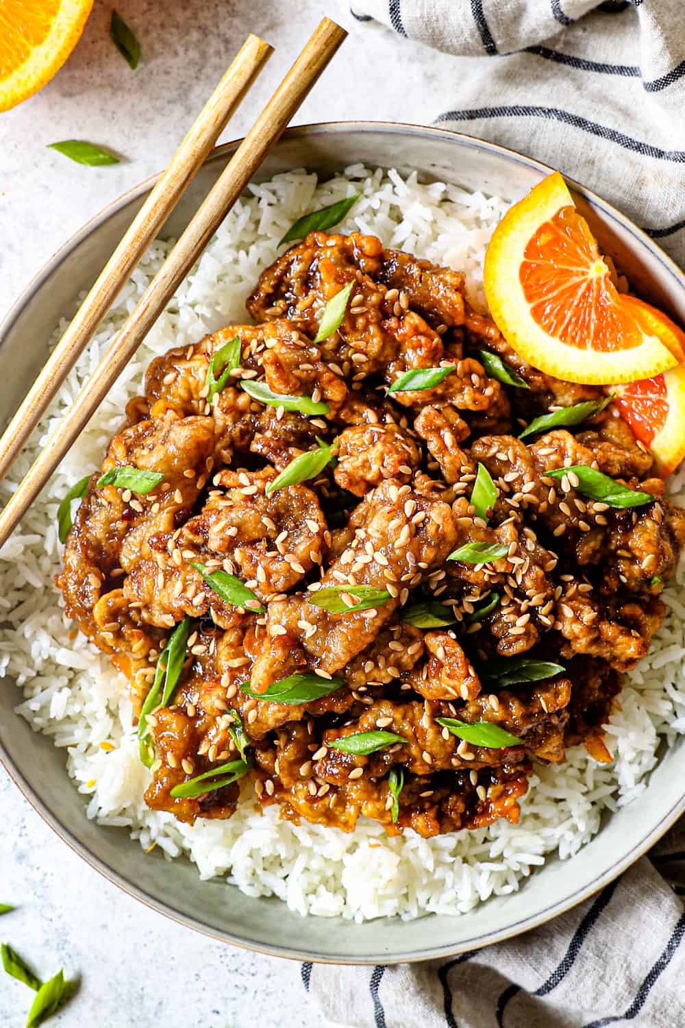top view showing how to serve orange beef recipe over a bed of white steamed rice