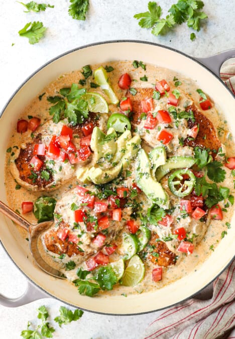 top view of smothered chicken recipe garnished with tomatoes