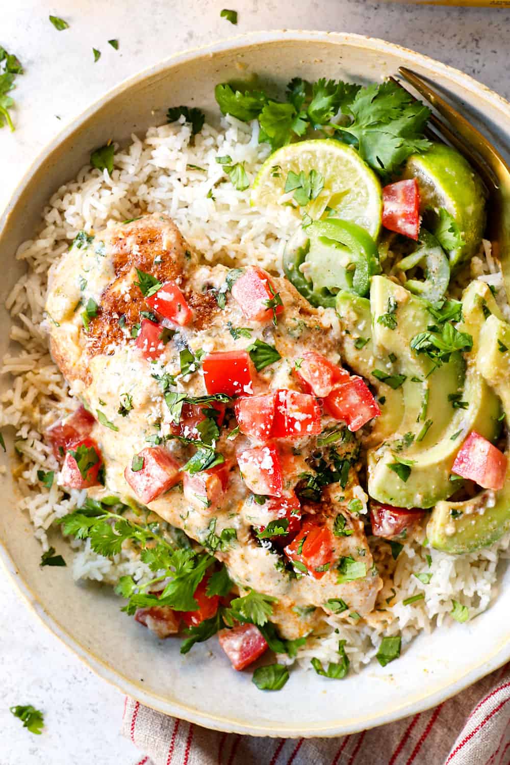 showing how to serve smothered chicken by adding to a bowl of rice