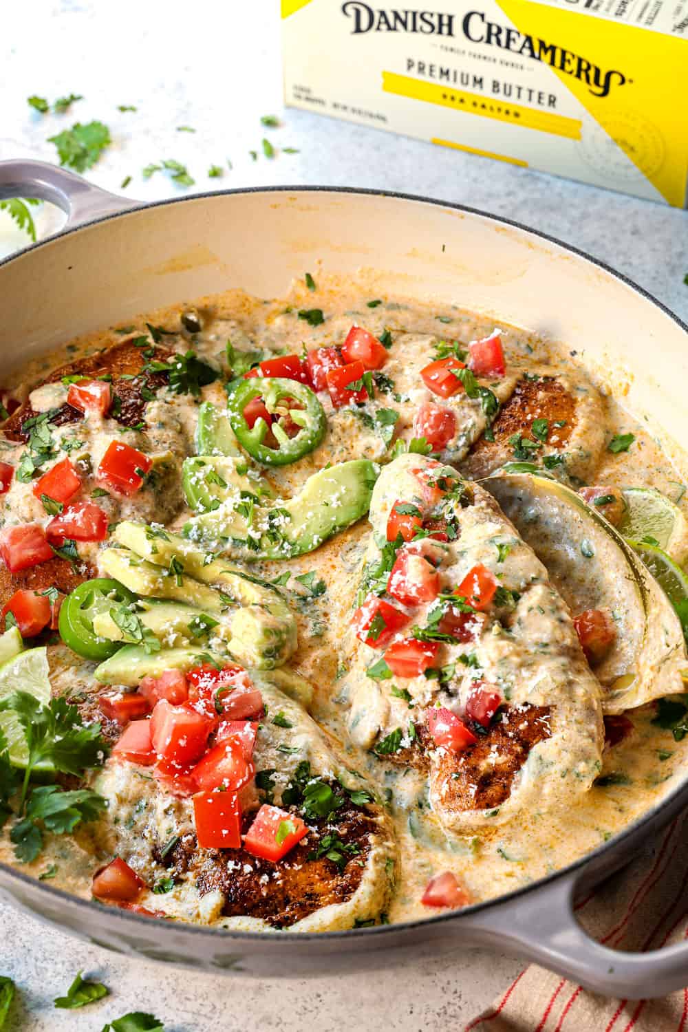 serving smothered chicken breasts in a creamy sauce