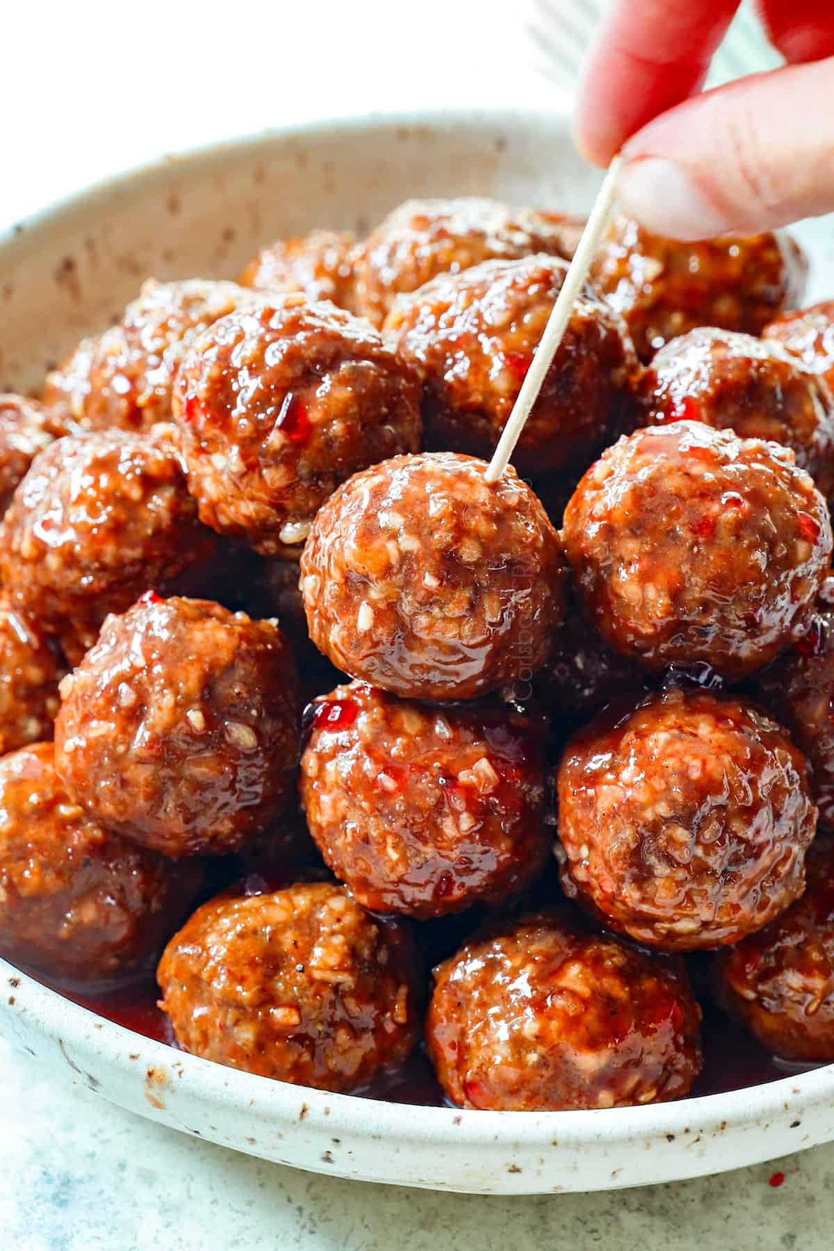 serving meatballs with grape jelly as an appetizer with toothpicks