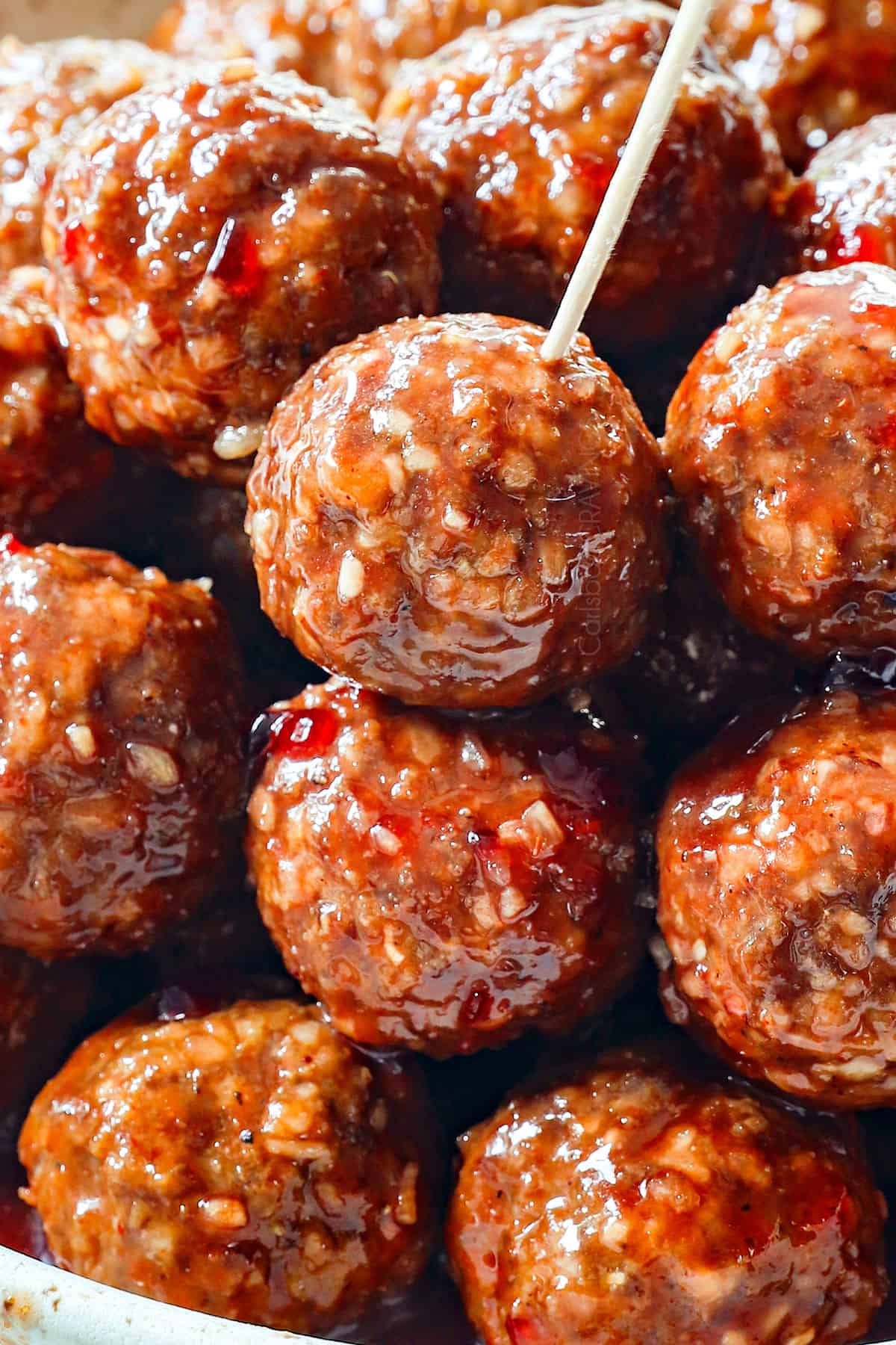 up close of serving grape jelly meatball recipe with toothpicks showing how tender and juicy they are
