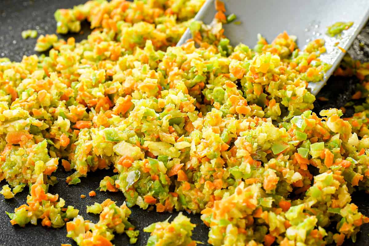 showing how to make easy meatloaf by sautรฉing the vegetables in a pan to soften