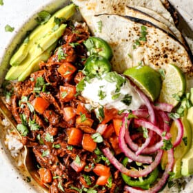 showing how to serve chicken mole by serving with pic de gallo, rice and warm flour tortillas in a bowl