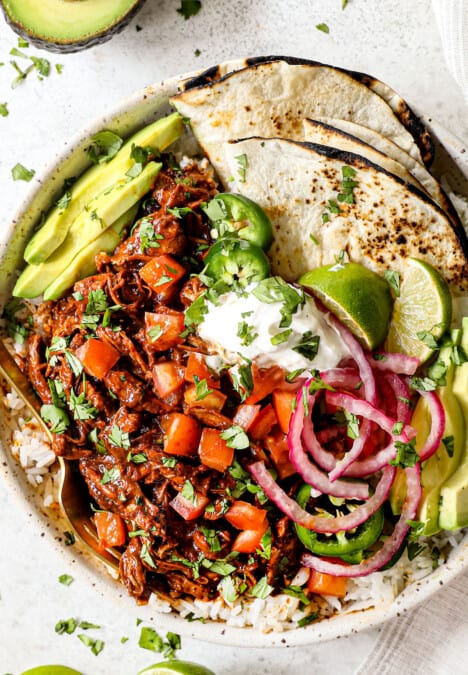 showing how to serve chicken mole by serving with pic de gallo, rice and warm flour tortillas in a bowl