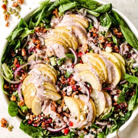 up close of serving pear salad with gorgonzola in a white bowl