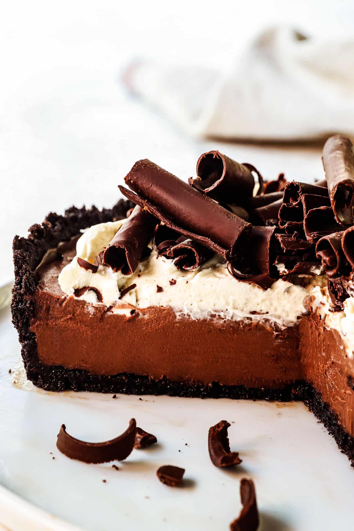 chocolate cream pie with a few pieces missing showing the creamy chocolate custard filling
