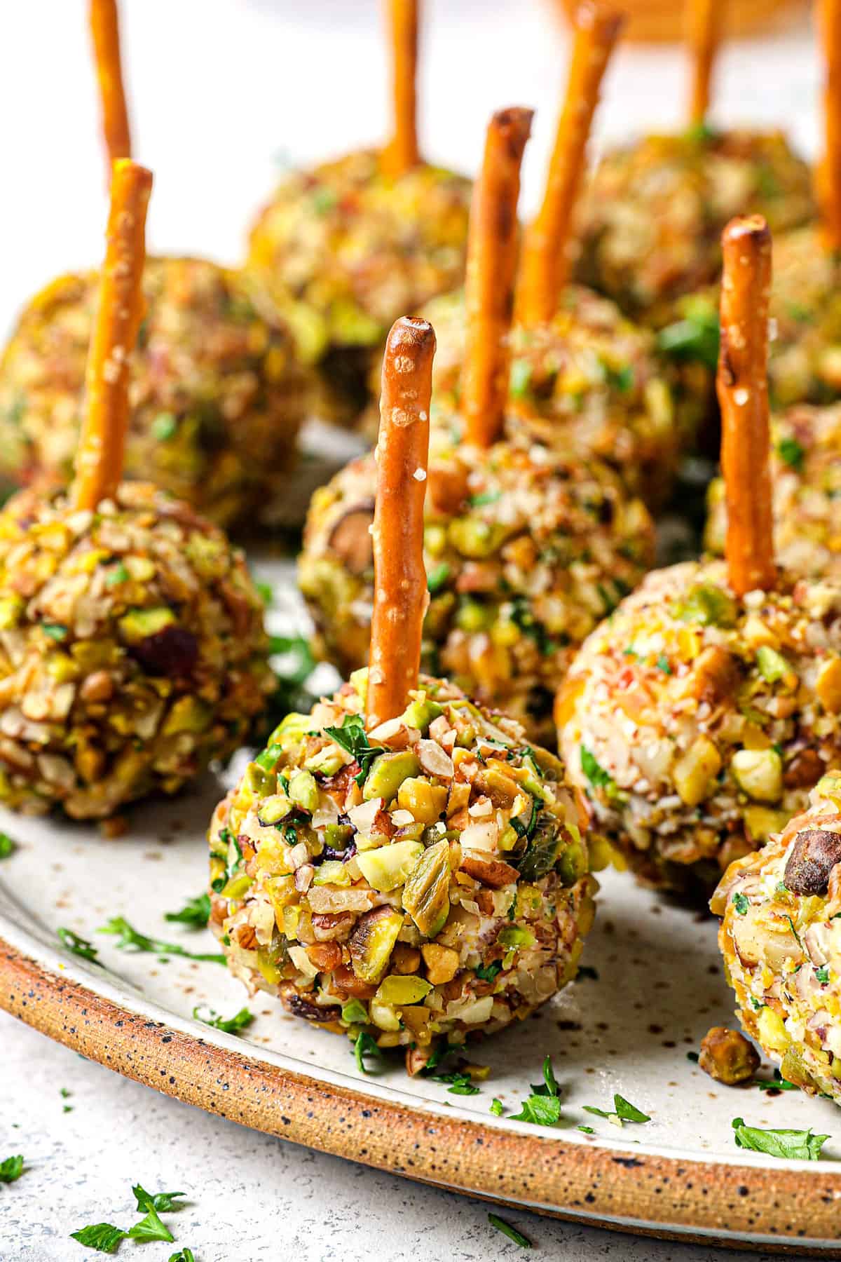 up close of mini cheese balls with pecan coating served on a platter