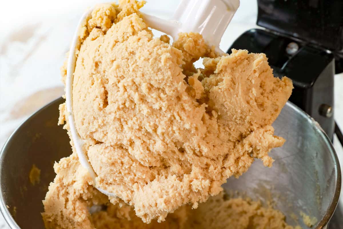 showing how to make pecan pie cookies by adding the eggs and mixing until combined