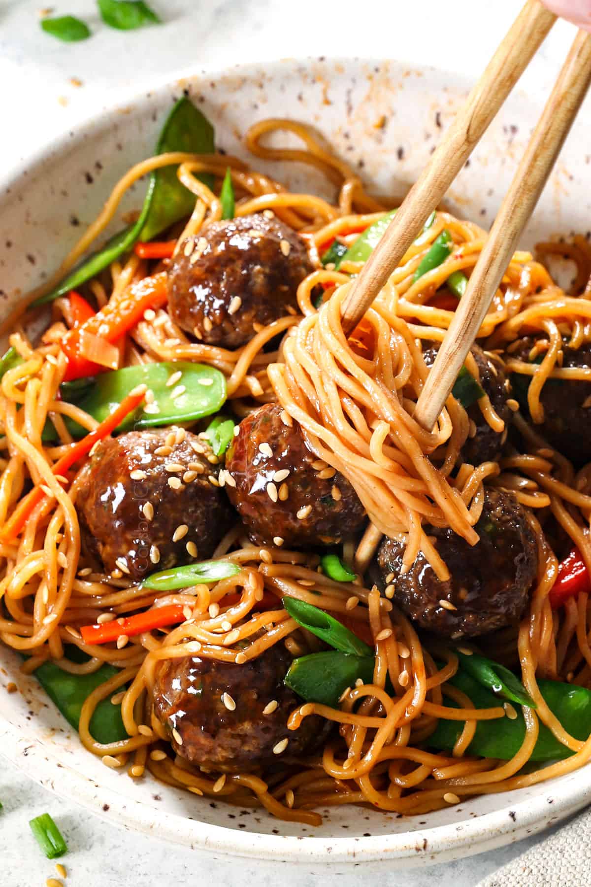 serving Asian meatballs in a bowl with sticky sauce