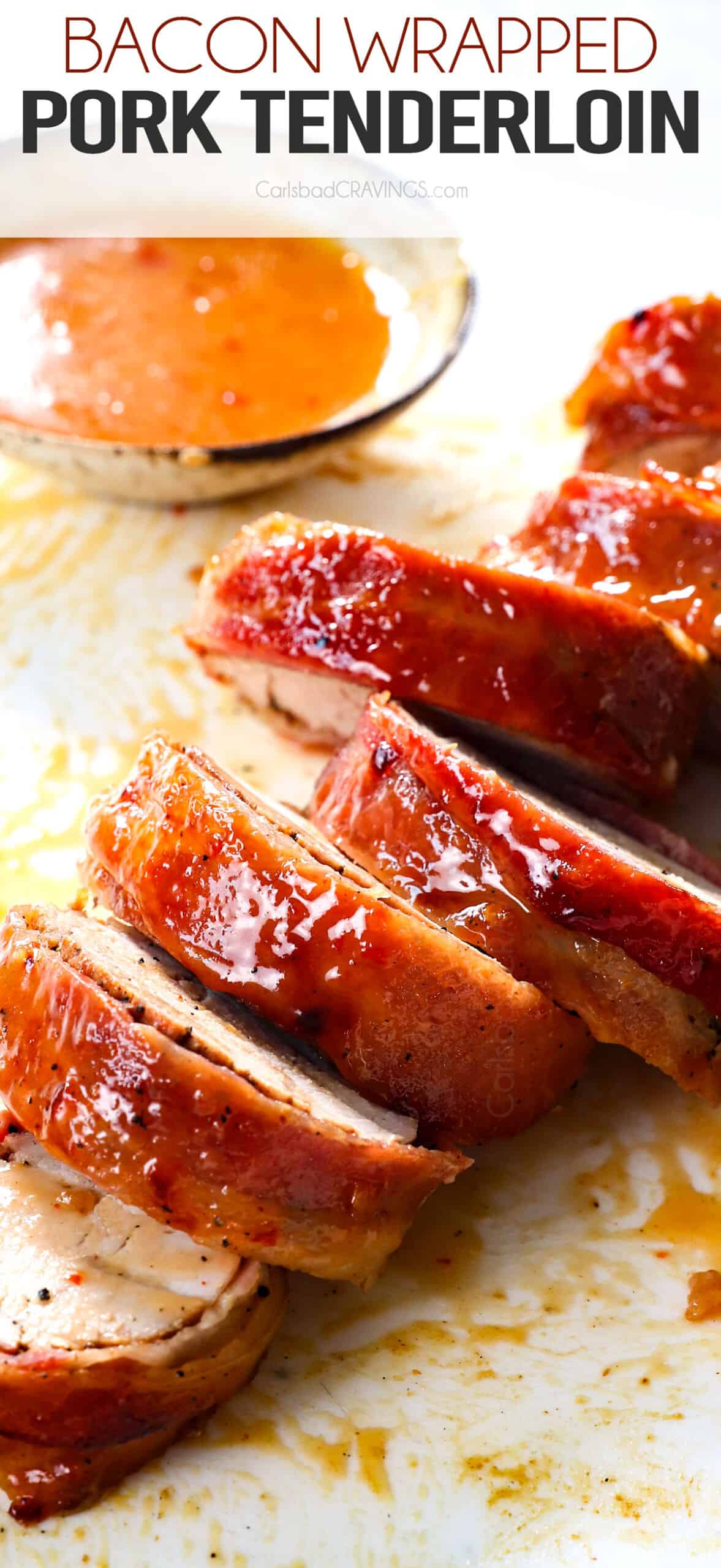 up close of bacon wrapped pork tenderloin cut in slices on a cutting board