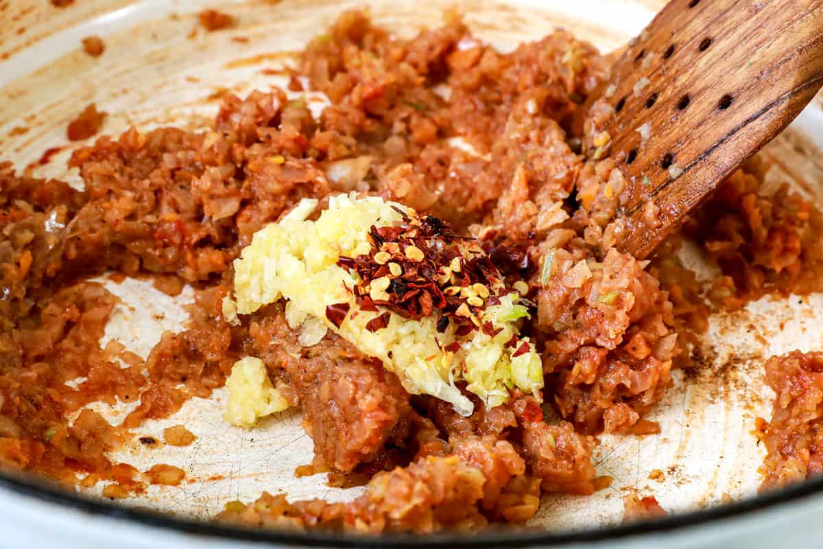 showing how to make beef ragu recipe by sautรฉing the onions, carrots and celery with garlic and red pepper flakes