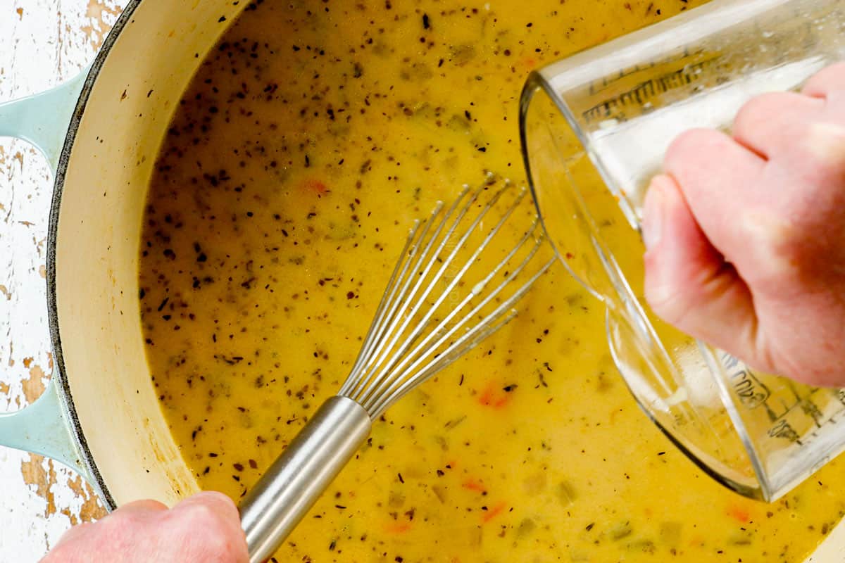 showing how to make traditional Avgolemono Soup recipe (Greek Lemon Chicken Soup) by whisking the avgolemono (lemon, eggs and broth) back into the soup