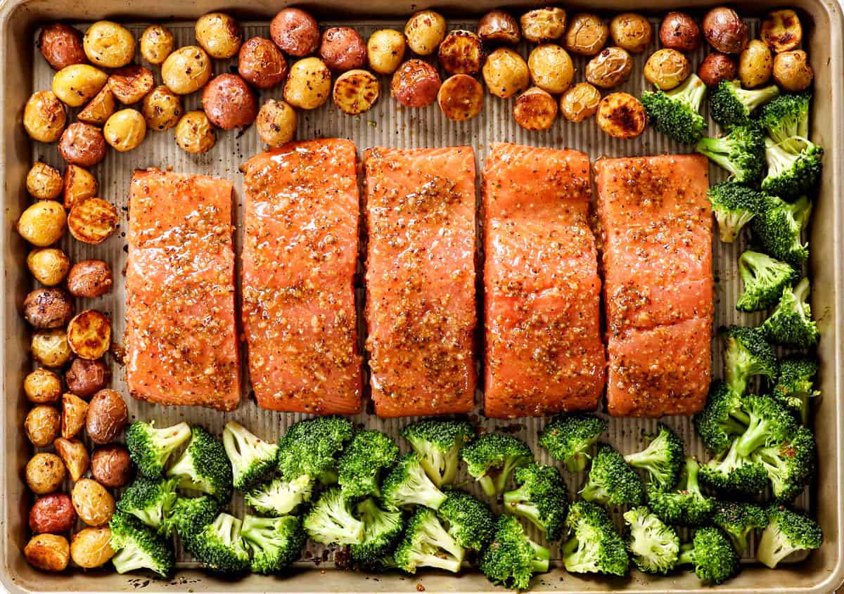 showing how to make easy honey mustard salmon by arranging the salmon fillets on a baking sheet