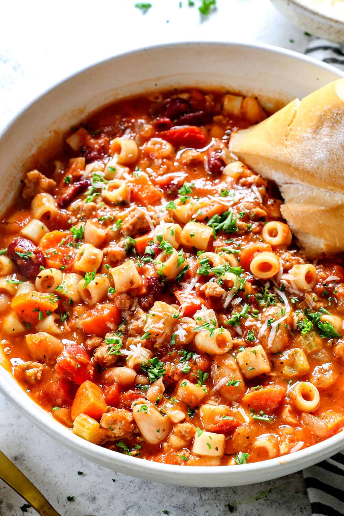 up close of pasta fagioli (pasta fazool) garnished by Parmesan
