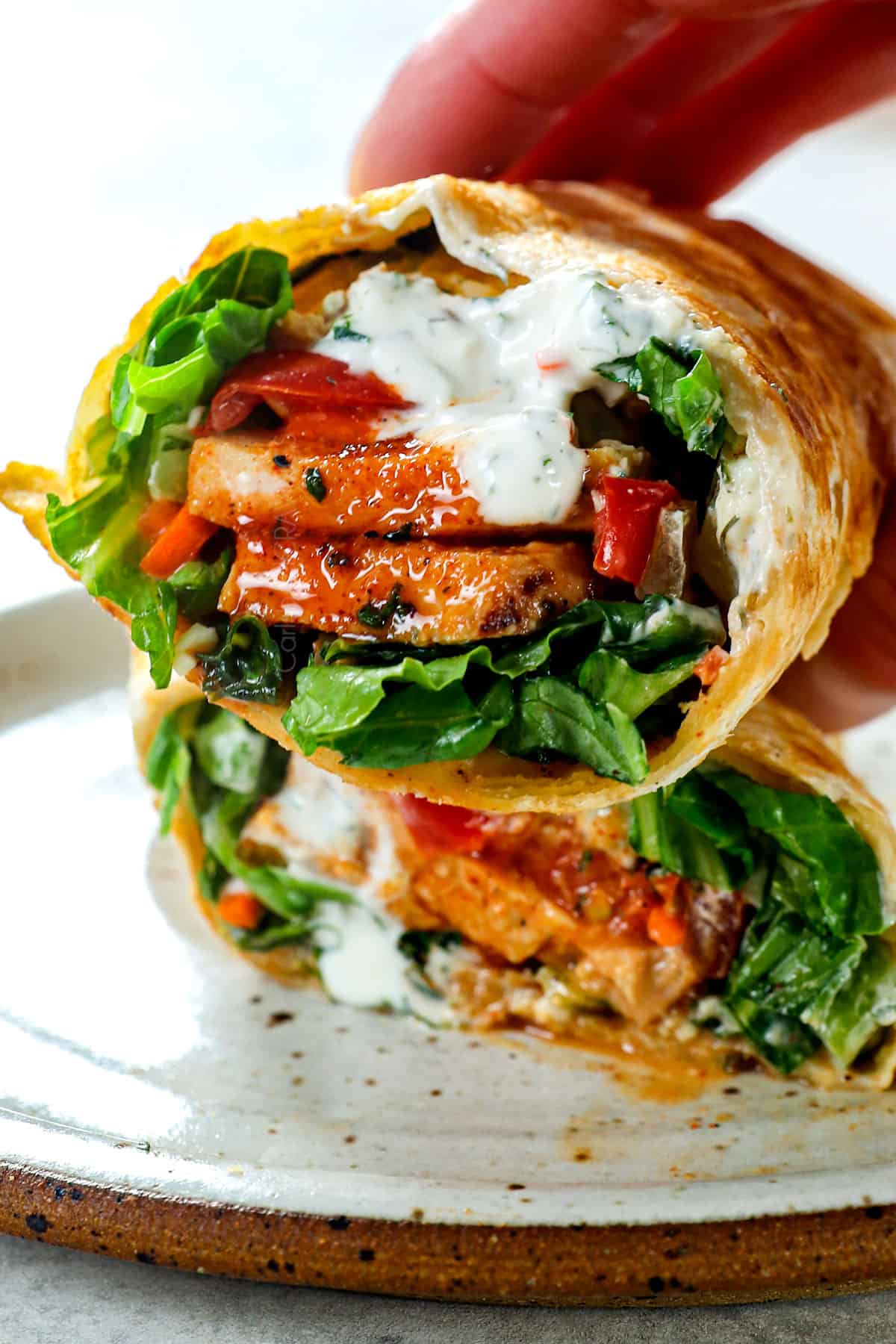 picking up buffalo chicken wraps showing the filling ingredients