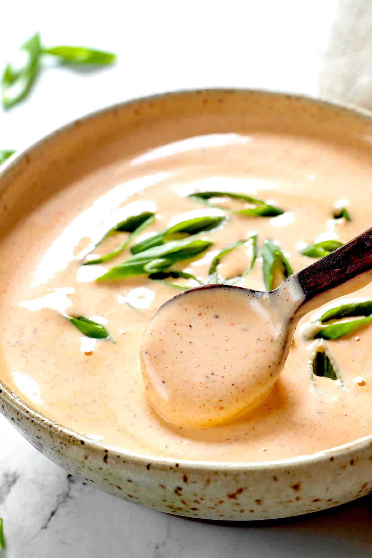 showing how to make hibachi chicken recipe by whisking together yum yum sauce