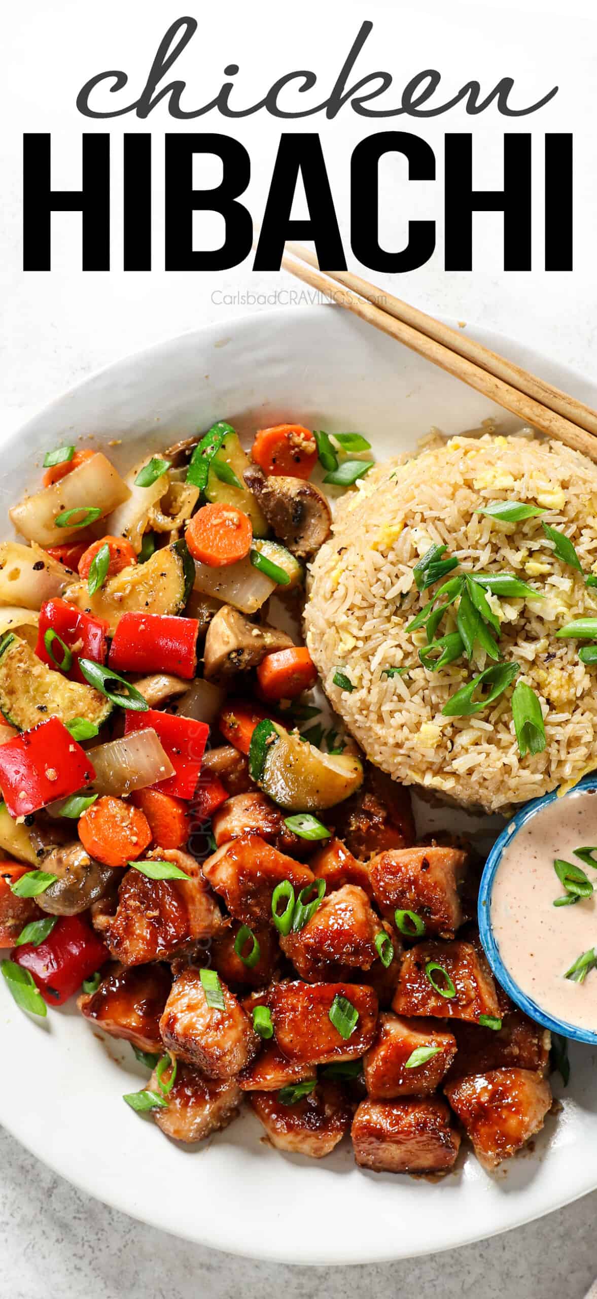 showing how to serve hibachi chicken on a plate with stir fried vegetables, fried vegetables and yum yum sauce