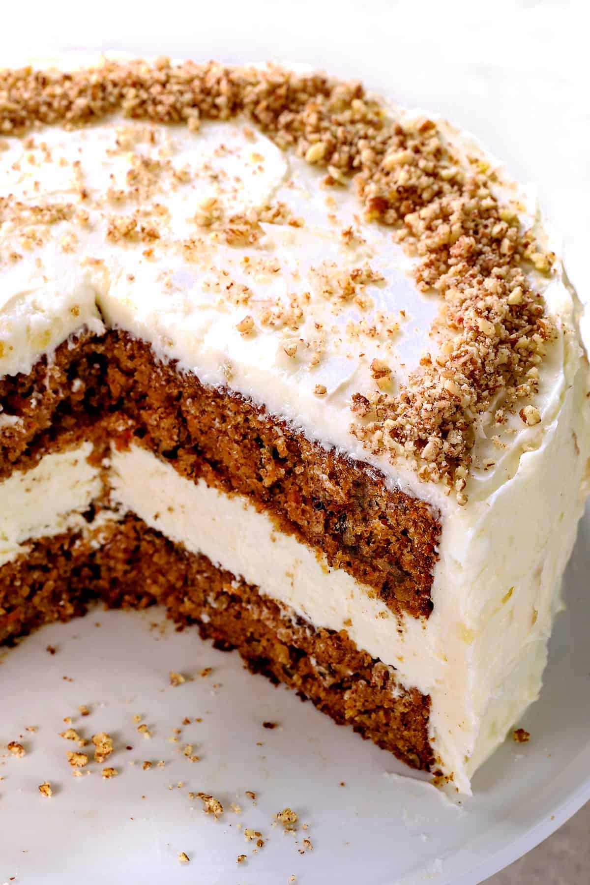 serving carrot cake cheesecake recipe on a pedestal