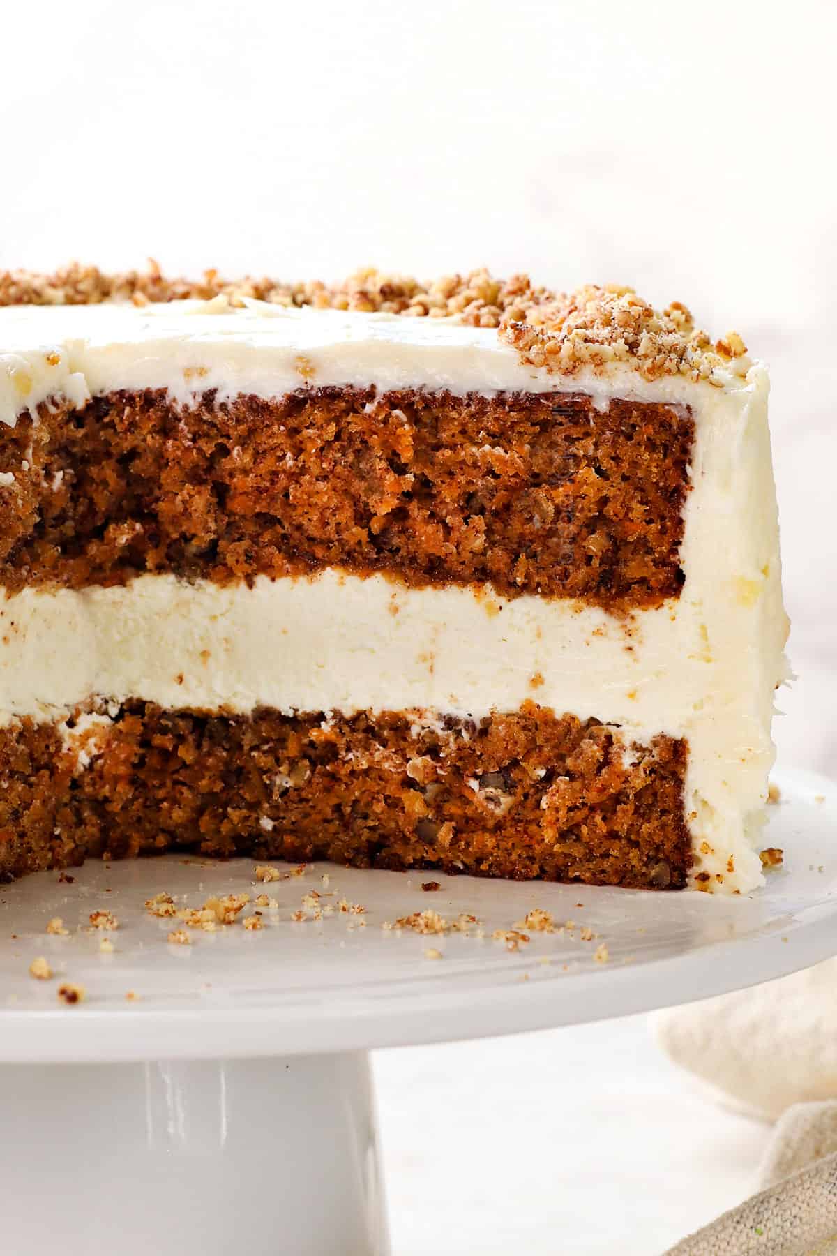 layered carrot cake cheesecake with moist carrot cake and frosting
