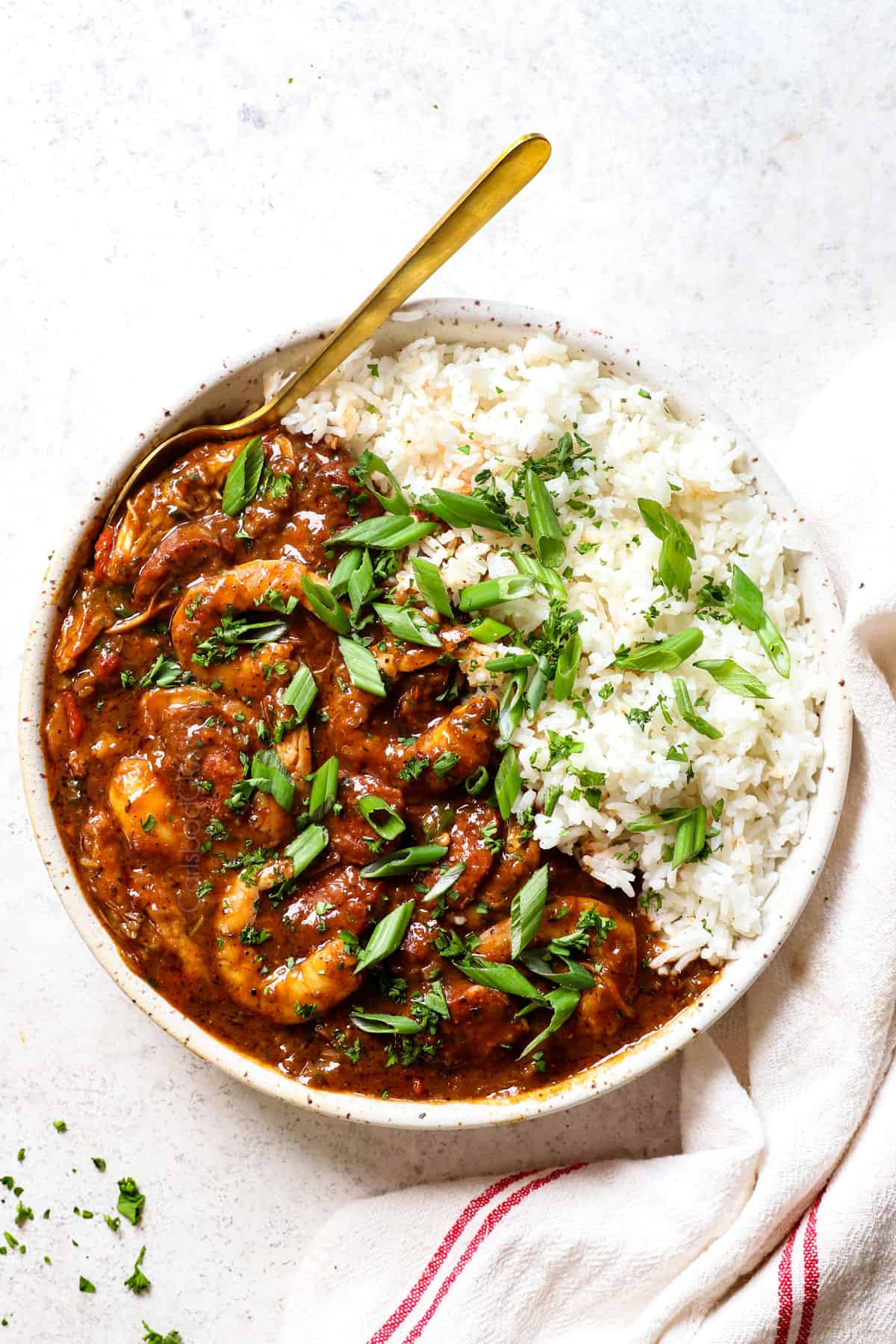 showing how to serve chicken and sausage gumbo in a bowl with rice