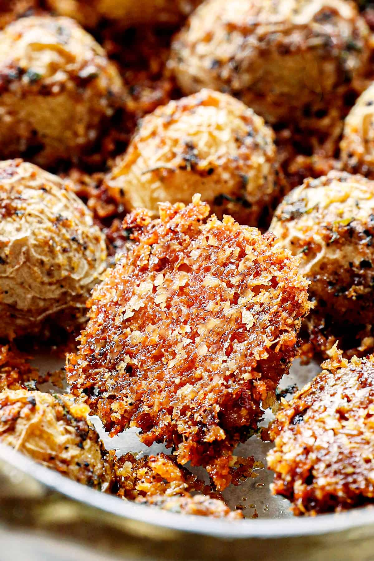 up close of Parmesan potatoes showing how crispy the Parmesan crust is