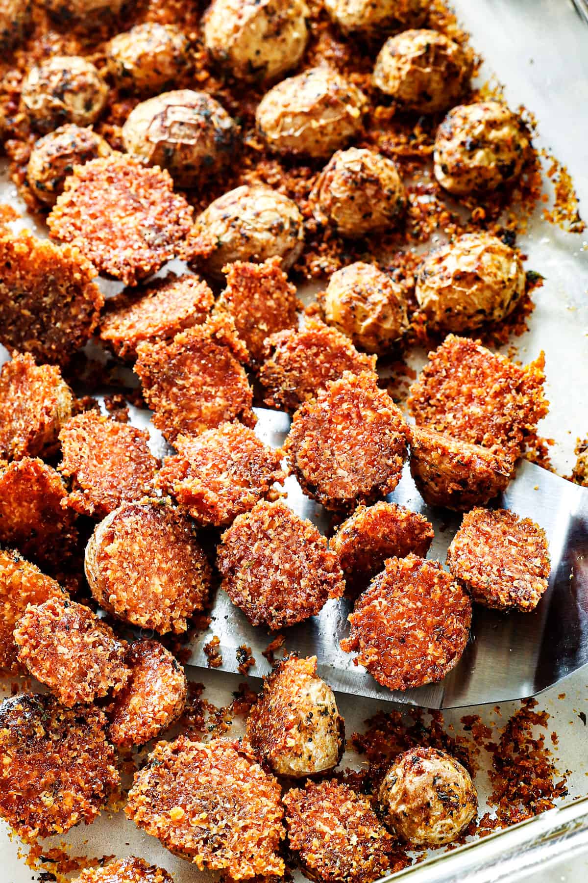showing how to make crispy roasted potatoes with Parmesan by separating the potatoes after baking in the oven