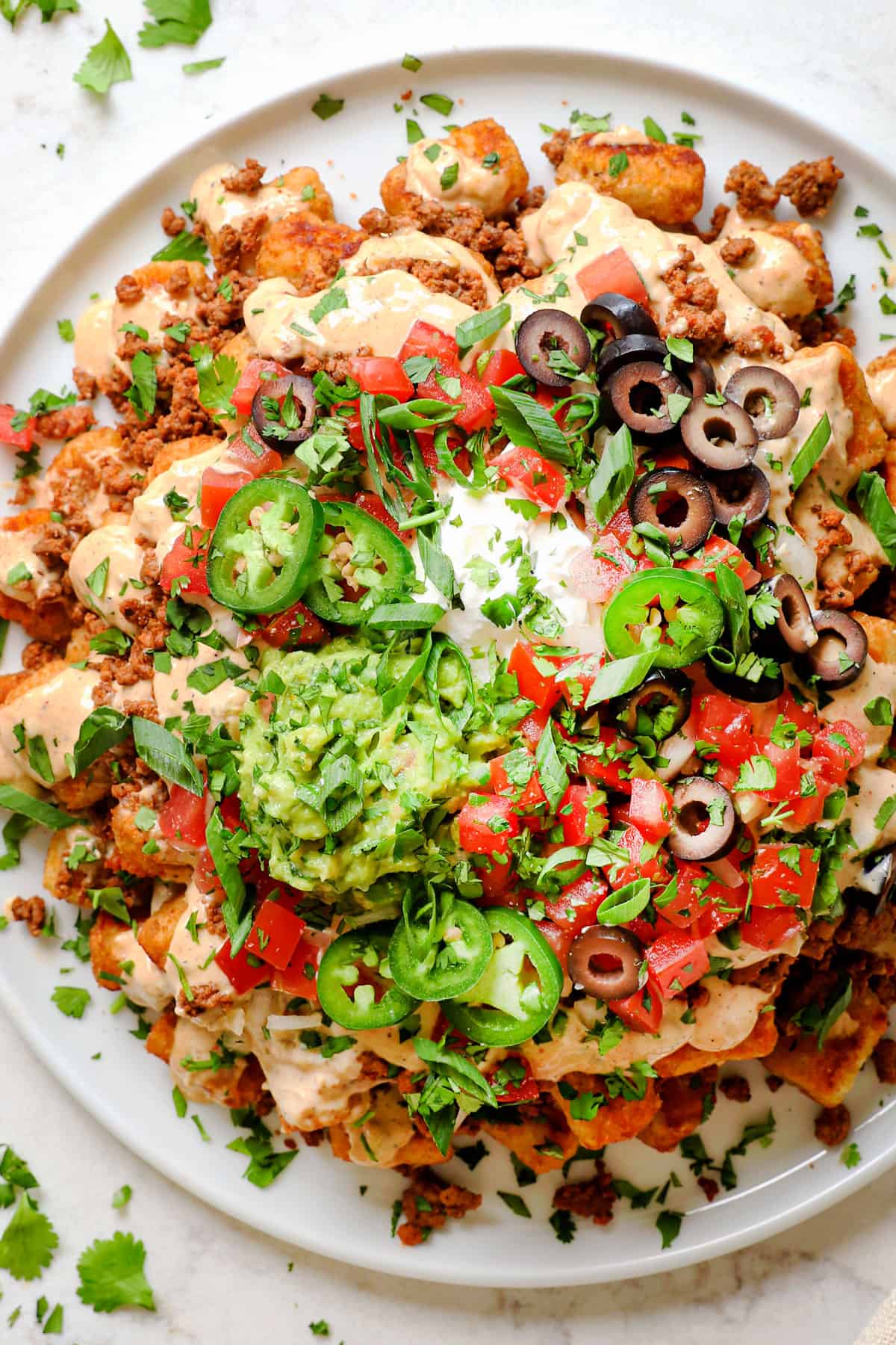 top view of tater tot nachos (totchos) made with tater tots, cheese sauce, ground beef and tater tots