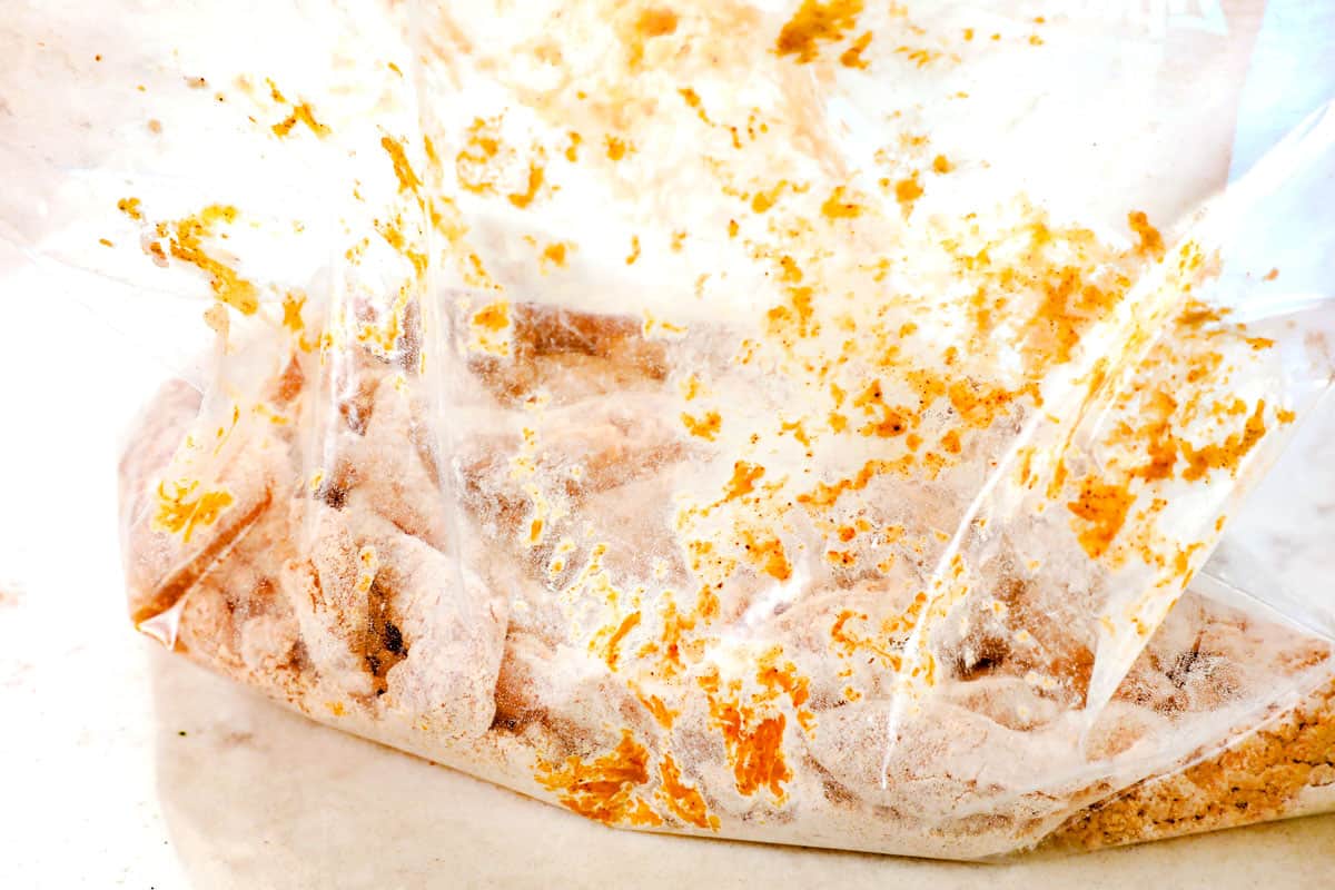 showing how to make spicy Dragon Chicken by breading chicken strips in flour, cornstarch and spices