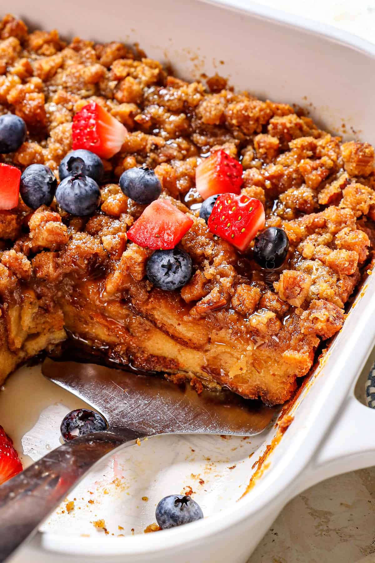up close of serving a slice of French Toast Casserole showing the perfect texture of soft bread (never soggy or mushy)
