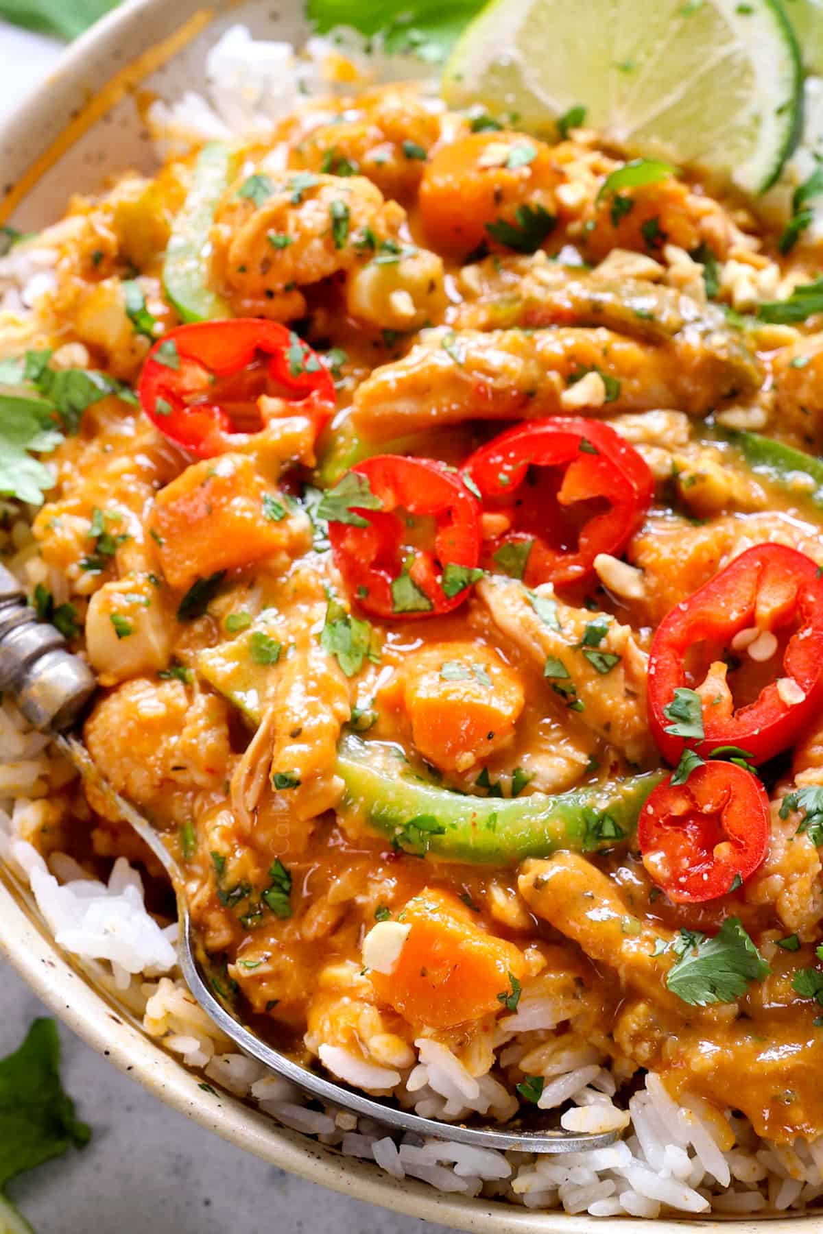 up close of a spoonful of crockpot Thai curry chicken showing how creamy it is
